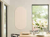 Dining room with a table set for a meal, featuring a vase of flowers and a Felt Right wall art design in the shade of green