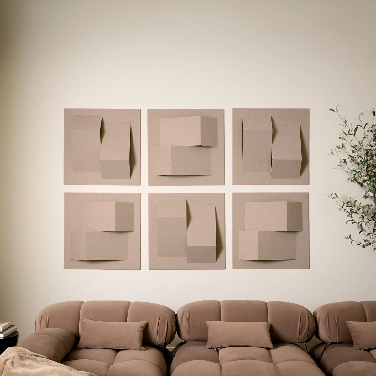 Tan felt acoustic tiles with points of dimension above a couch