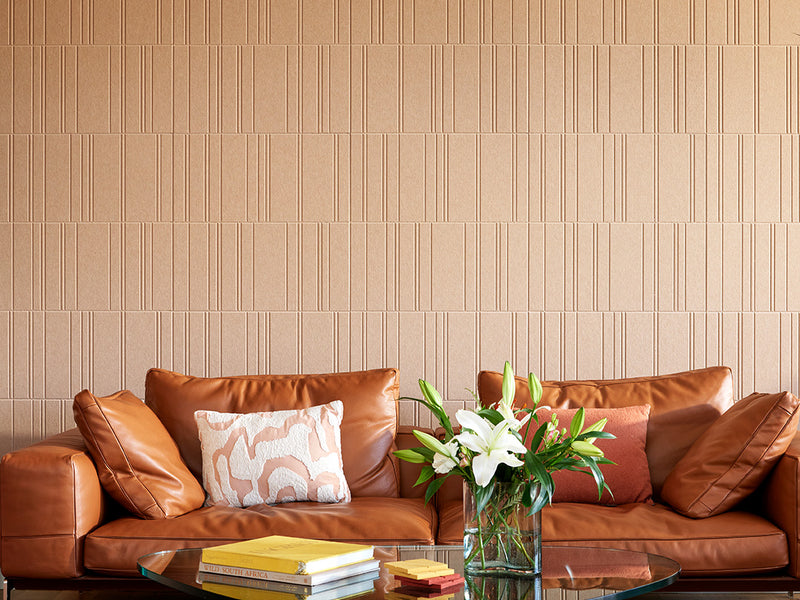 Brown engraved wall tiles above leather couch