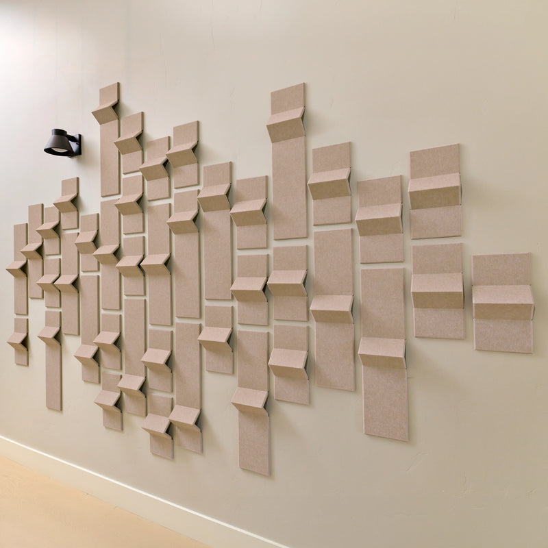 Tan felt acoustic tiles with points of dimension to create a modern design