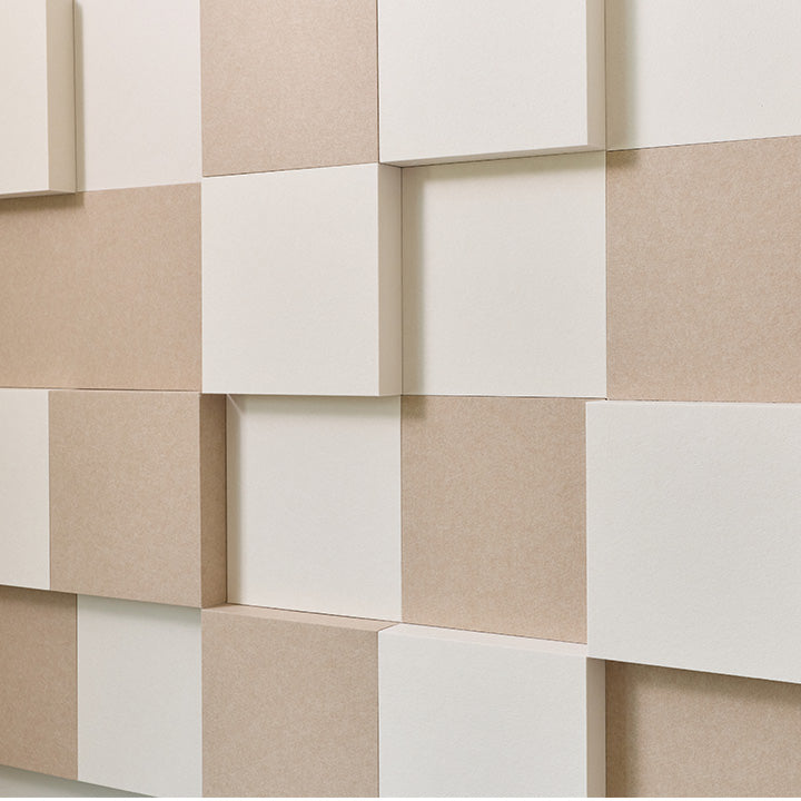 3D geometric wall panels in alternating off-white and warm beige tones, arranged in a staggered cube pattern.