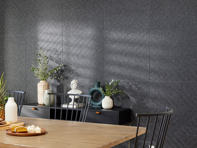 A Felt Right wall art design in a dark shade of grey on a kitchen wall next to a dinning table