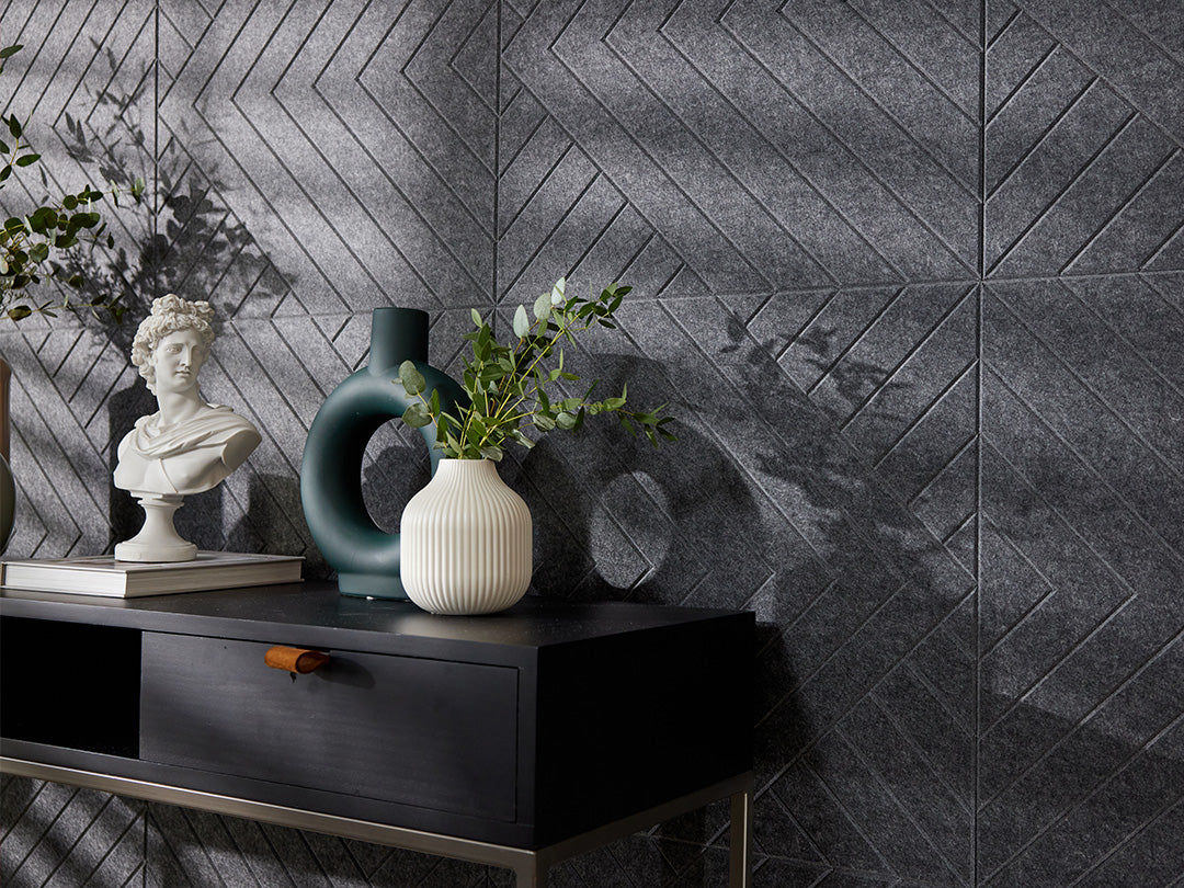 A Felt Right wall art design in a dark shade of grey on a kitchen wall next to a dinning table