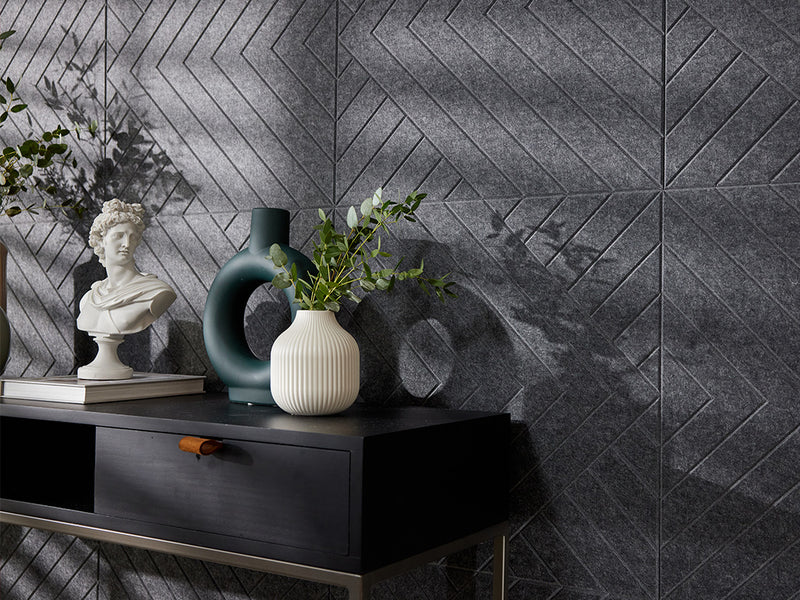 A Felt Right wall art design in a dark shade of grey on a kitchen wall next to a dinning table