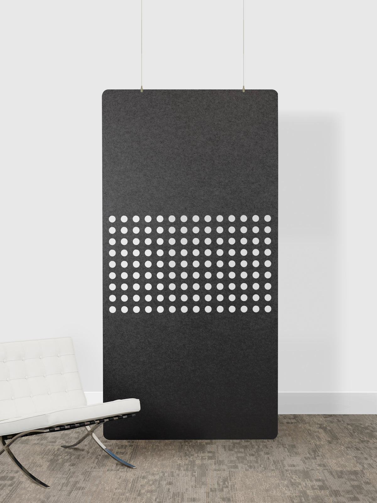 Black acoustic panel with white dot pattern on a white wall