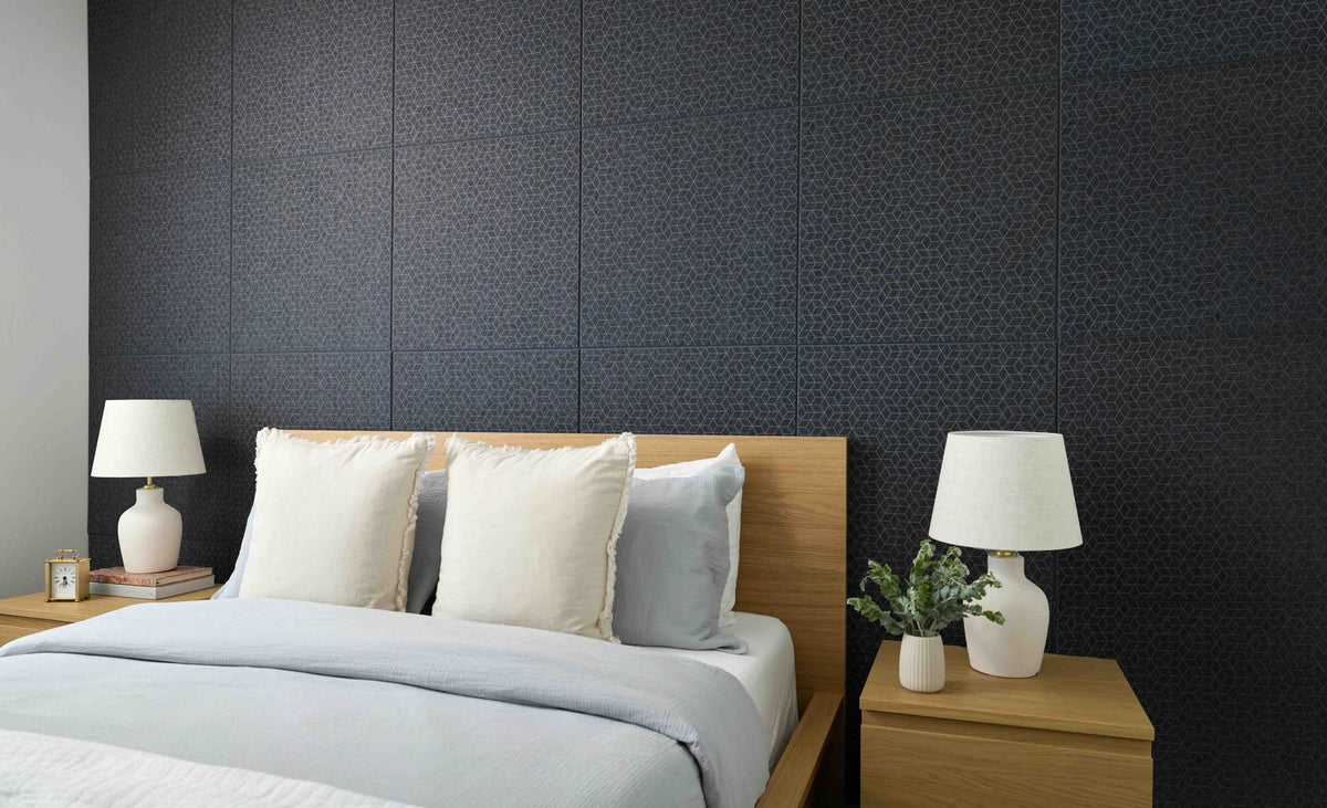 Modern bedroom with a bed, nightstands, and lamps against a dark textured wall.