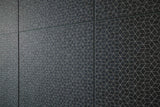 Patterned black tiles on a wall