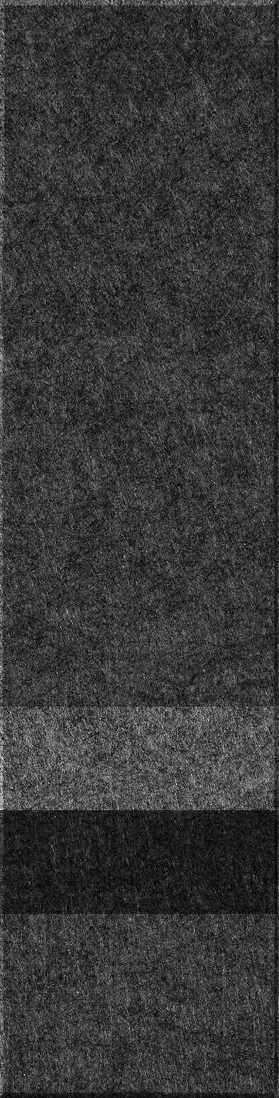 A felt tile that is dark gray on the top, lighter gray, black, and then a dark gray bottom. 