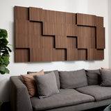 Walnut wooden acoustic boxes installed on white wall above couch