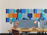 Felt Right wall art design on a white wall behind a desk in an office space. Felt tiles making a geometric wall art design.