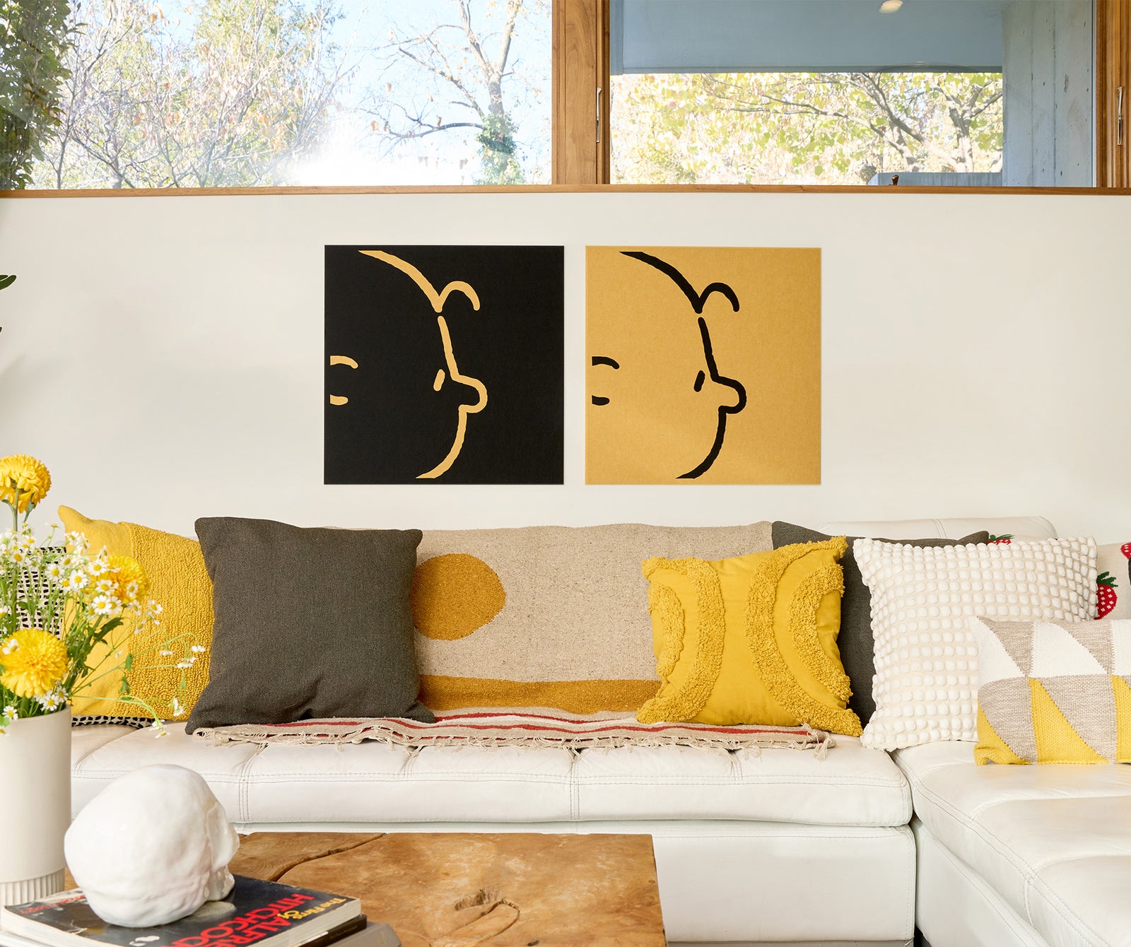 Charlie Brown themed wall art installed above a couch.