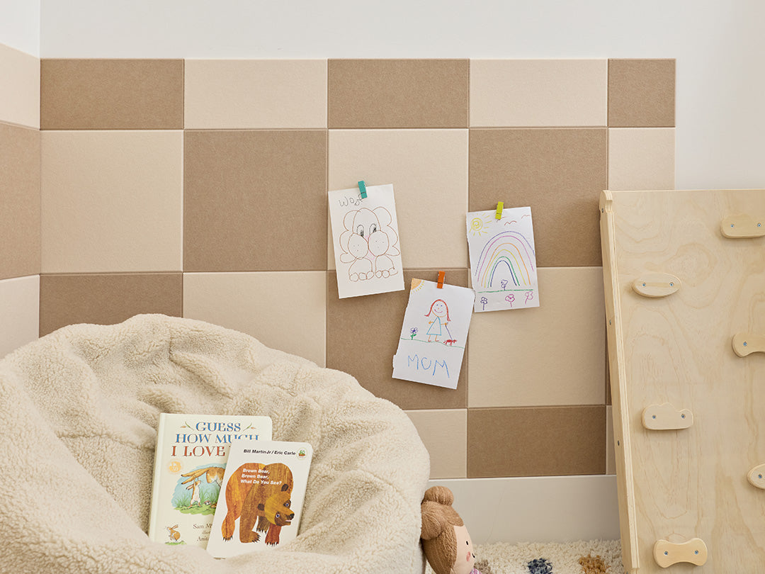 Children's playroom with checkered wall, bean bag, toys, and a basket.
