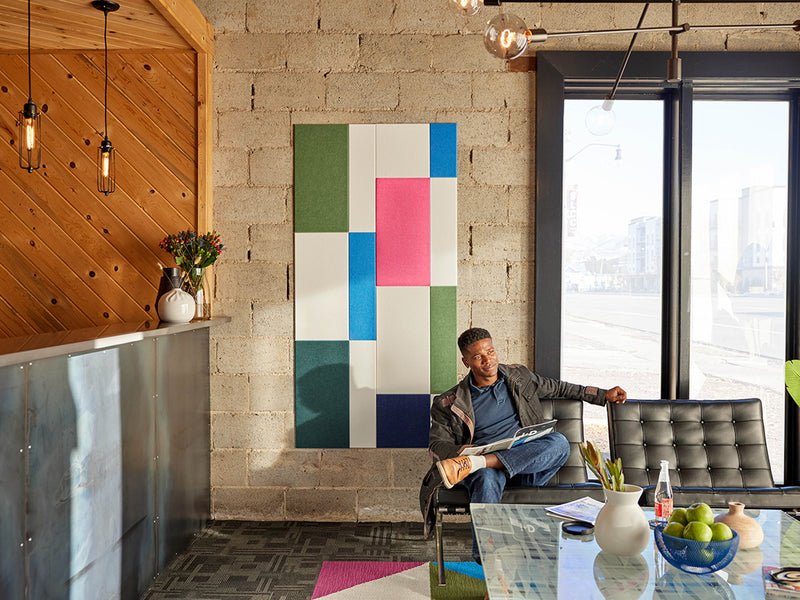 Colorful wall art and large windows.