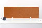 Tan leather desk divider with geometric line pattern and white metal supports, shown on desk with mug and notepad.