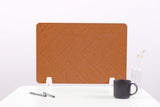 Tan felt desk divider with chevron pattern and white mounting brackets on white desk with coffee mug and pen holder.
