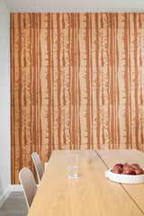 Dining area with a wooden table and chairs against a wall with vertical striped pattern.