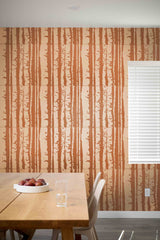 Dining area with a wooden table and chairs against a wall with vertical brown pattern.