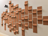 Three-dimensional terracotta tiles arranged in an abstract wall installation with varying heights and angles.