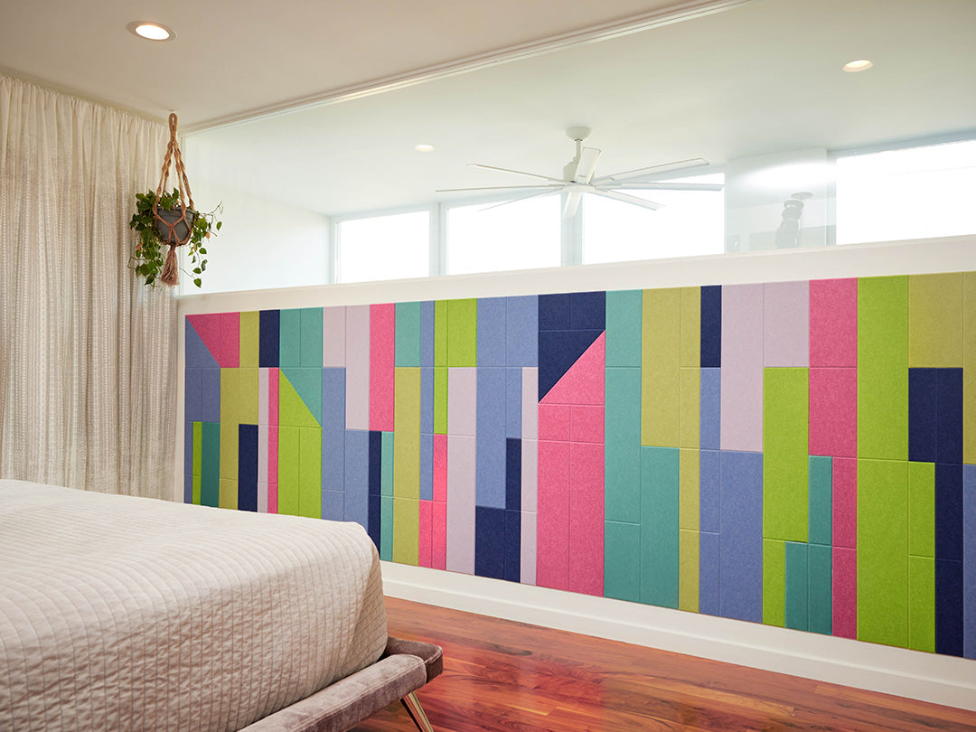 Colorful geometric wall art in a modern bedroom setting