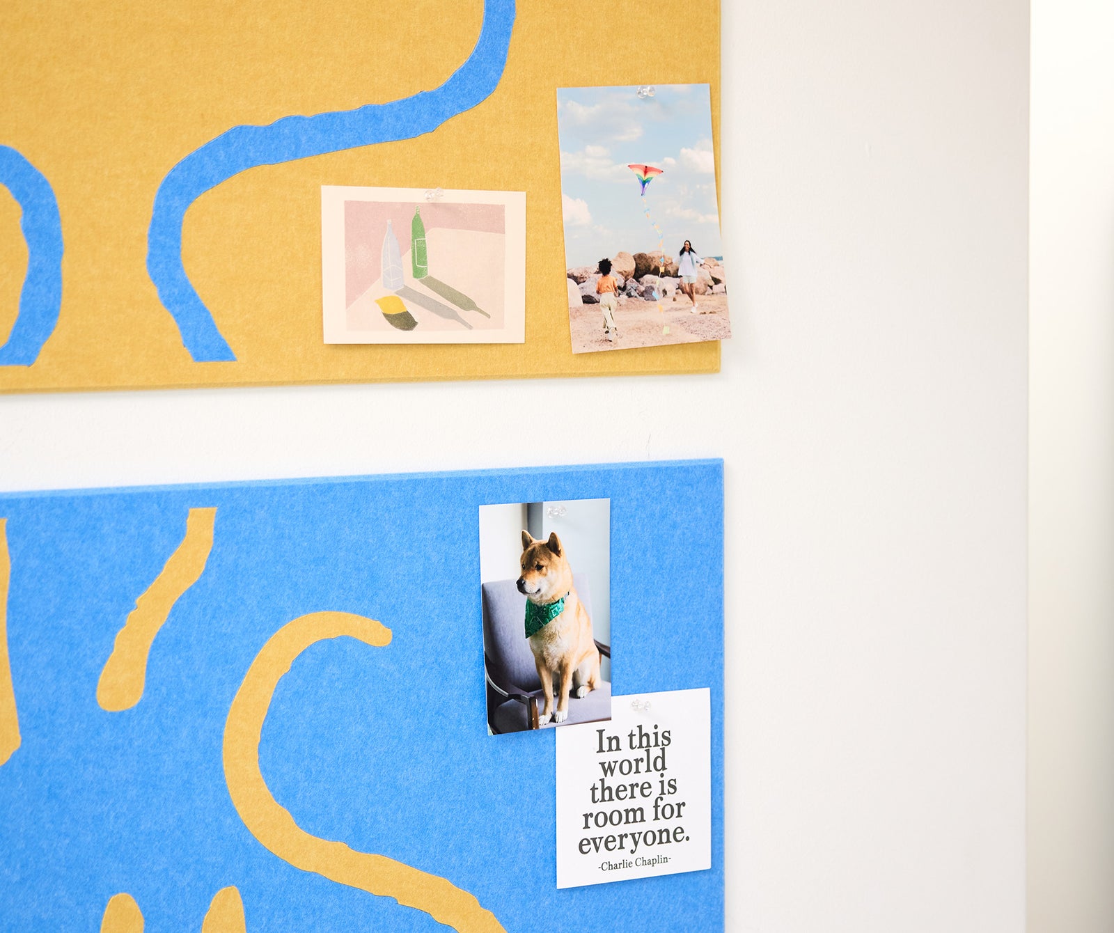 Close up of Felt Right Woodstock pinboard with photos pinned to it.