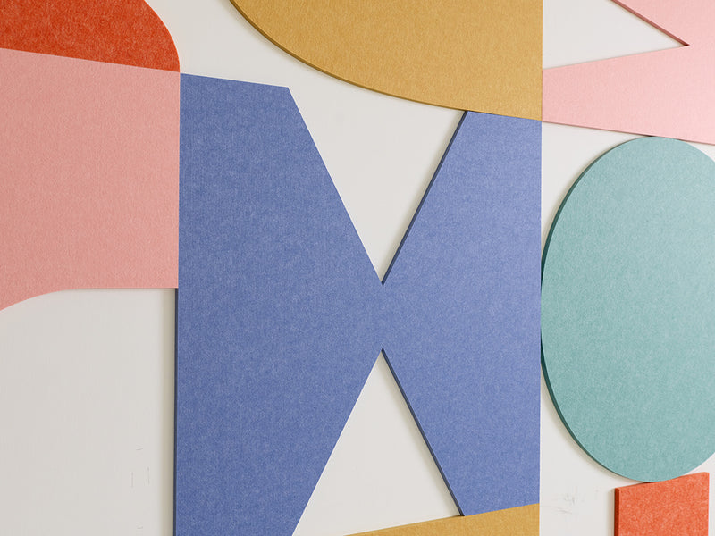 Colorful geometric acoustic tiles on a white background