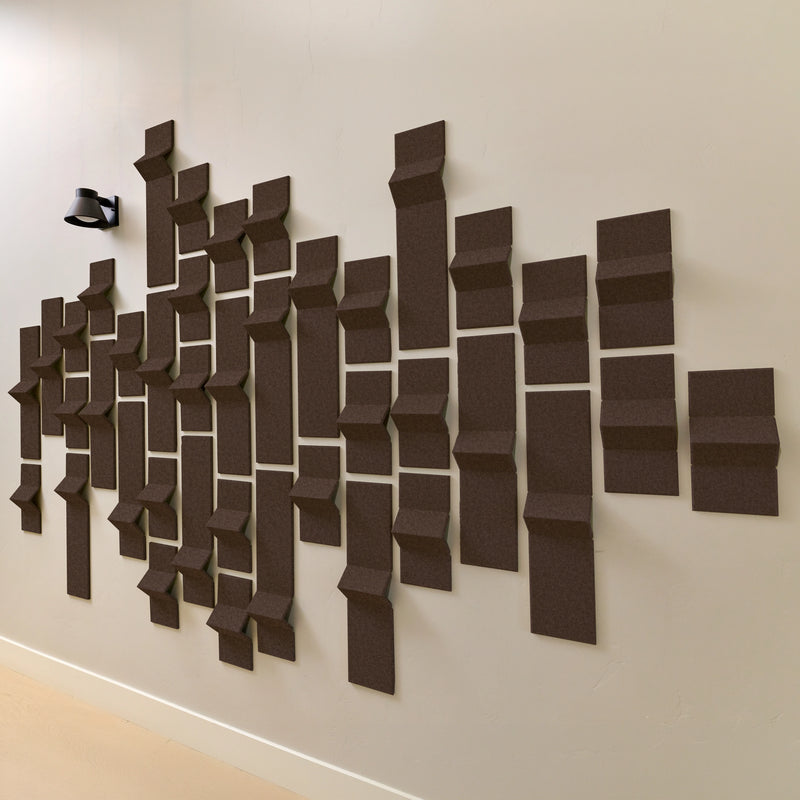 Dark brown acoustic felt tiles on a wall with points 