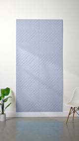 Blue-gray felt sheet with engraved chevron and diagonal line pattern arranged in a grid of rectangular sections.