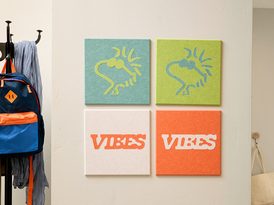 Wall with hooks, coats, backpacks, and colorful Woodstock Peanuts wall art in a room setting.