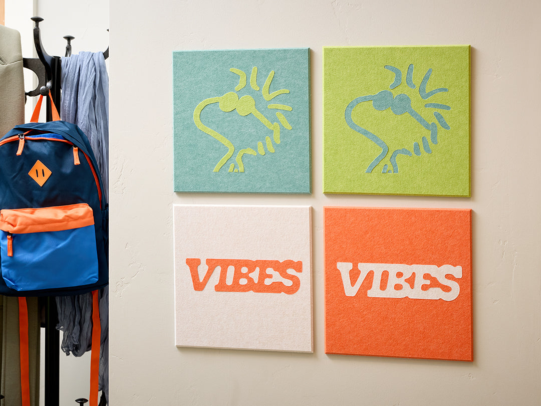 Wall with hooks, coats, backpacks, and colorful Woodstock Peanuts wall art in a room setting.