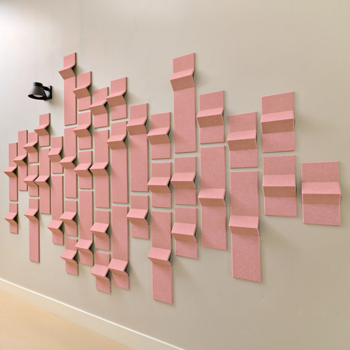Light pink acoustic tiles made of felt with peak dimensions