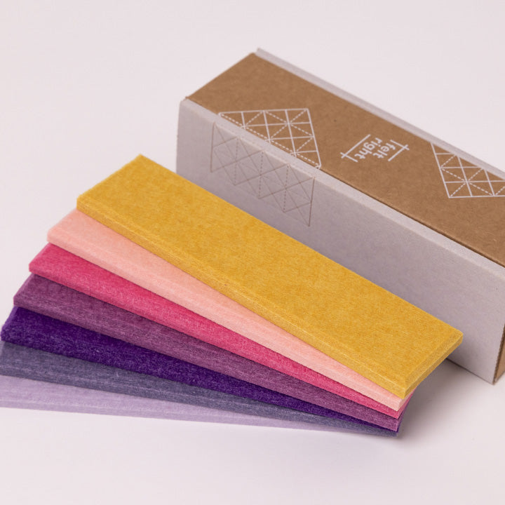 Yellow, pink, and purple colored felt samples with cardboard box