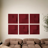 Red acoustic felt tiles with peak designs along a wall in a room with a couch and a plant