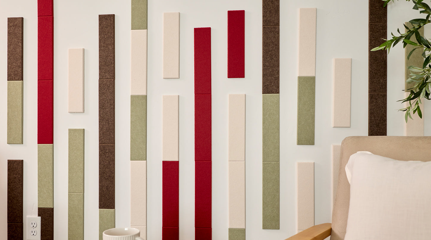 Two beige armchairs with wooden frames in front of a wall with vertical acoustic panels