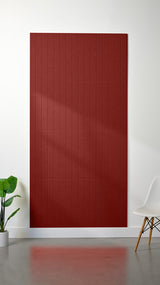 Large red felt sheet with evenly spaced parallel engraved lines running vertically across the surface.