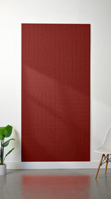 Red felt sheet with engraved geometric pattern of vertical lines and curved arcs arranged in quadrants.