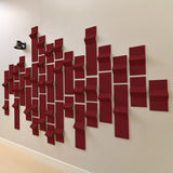 dark red acoustic felt tiles with points on a wall