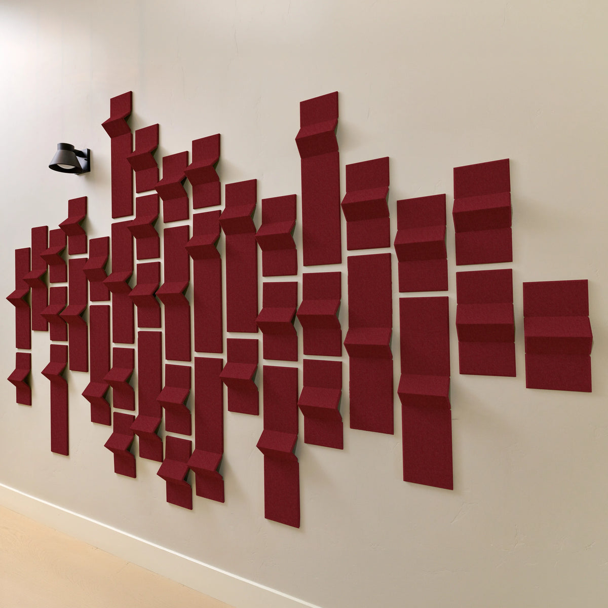 dark red acoustic felt tiles with points on a wall
