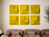 Six yellow dimensional tiles with geometric cutouts and layered surfaces arranged in a 2x3 grid on a wall.