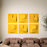 Yellow felt acoustic tiles on a wall above a couch in a room