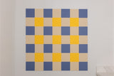 Gingham pinboard with blue, beige, and yellow checkered pattern squares.