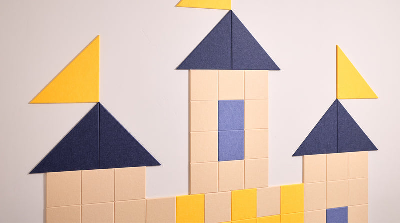 Children's room with a castle-shaped wall decoration made of colorful acoustic tiles.