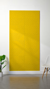 Yellow felt sheet with engraved diagonal line pattern creating geometric sections across the surface.