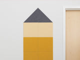 House-shaped pinboard with gray triangular roof, light yellow middle section, and golden yellow base divided into panels.