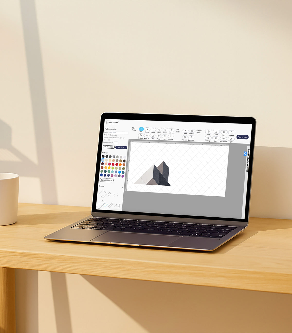 Design Studio website open on laptop on wood table
