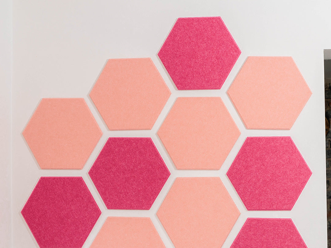 Hexagonal pink and coral tiles on a white background