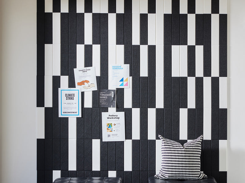 Felt Right wall art using black and white felt tiles to create a geometric pattern that is pinnable and on a white walls 