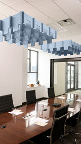 Blue and gray 3D cloud-shaped acoustic baffles suspended from ceiling in conference room.