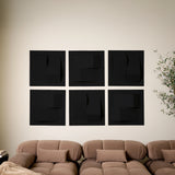 Black felt acoustic tiles in a room with a couch that creates a 3D design 