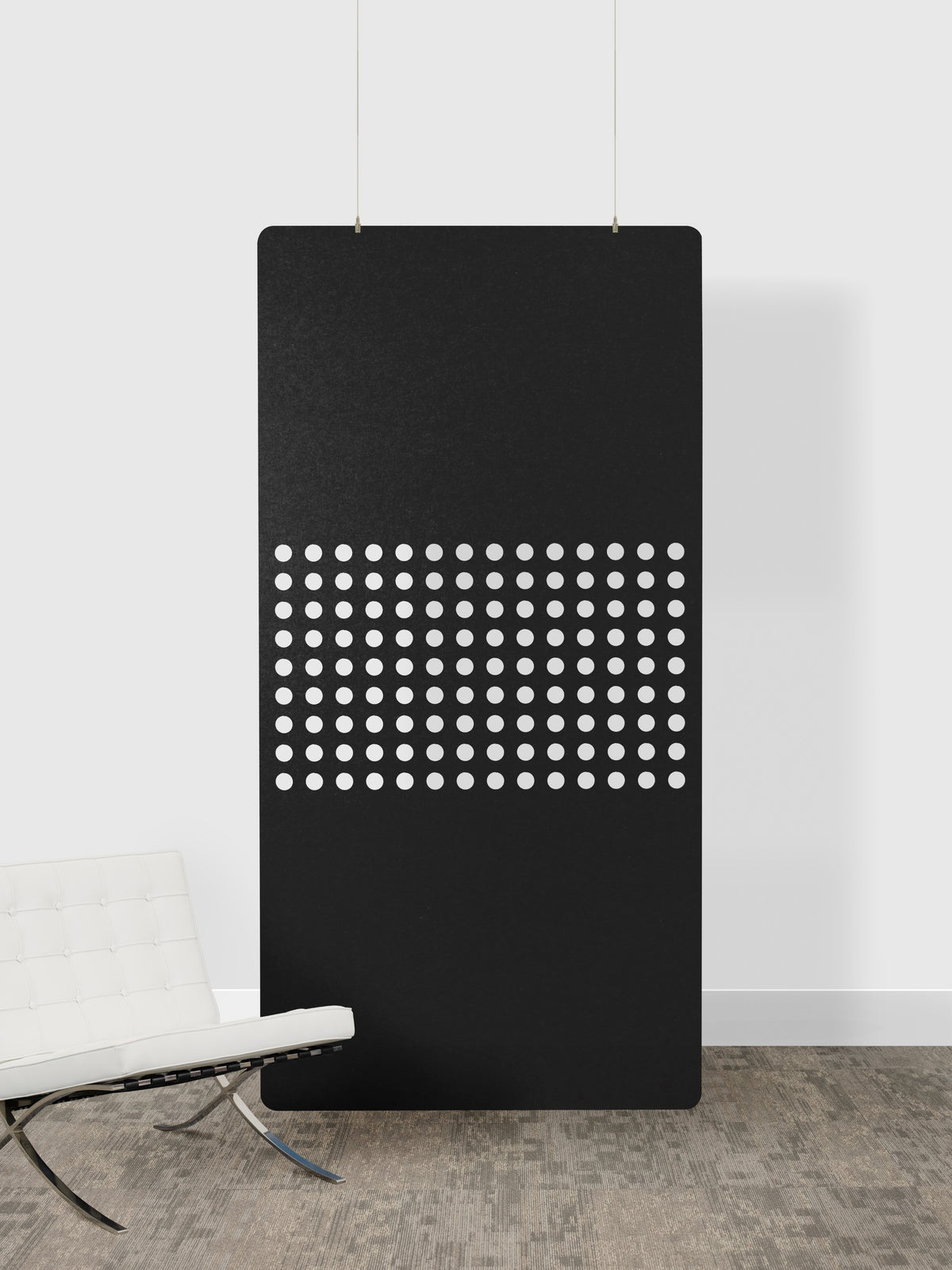 Black panel with white dot pattern on a white wall