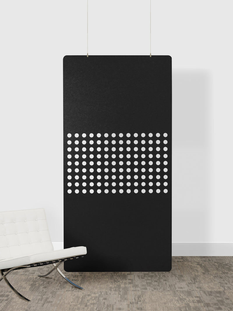Black panel with white dot pattern on a white wall